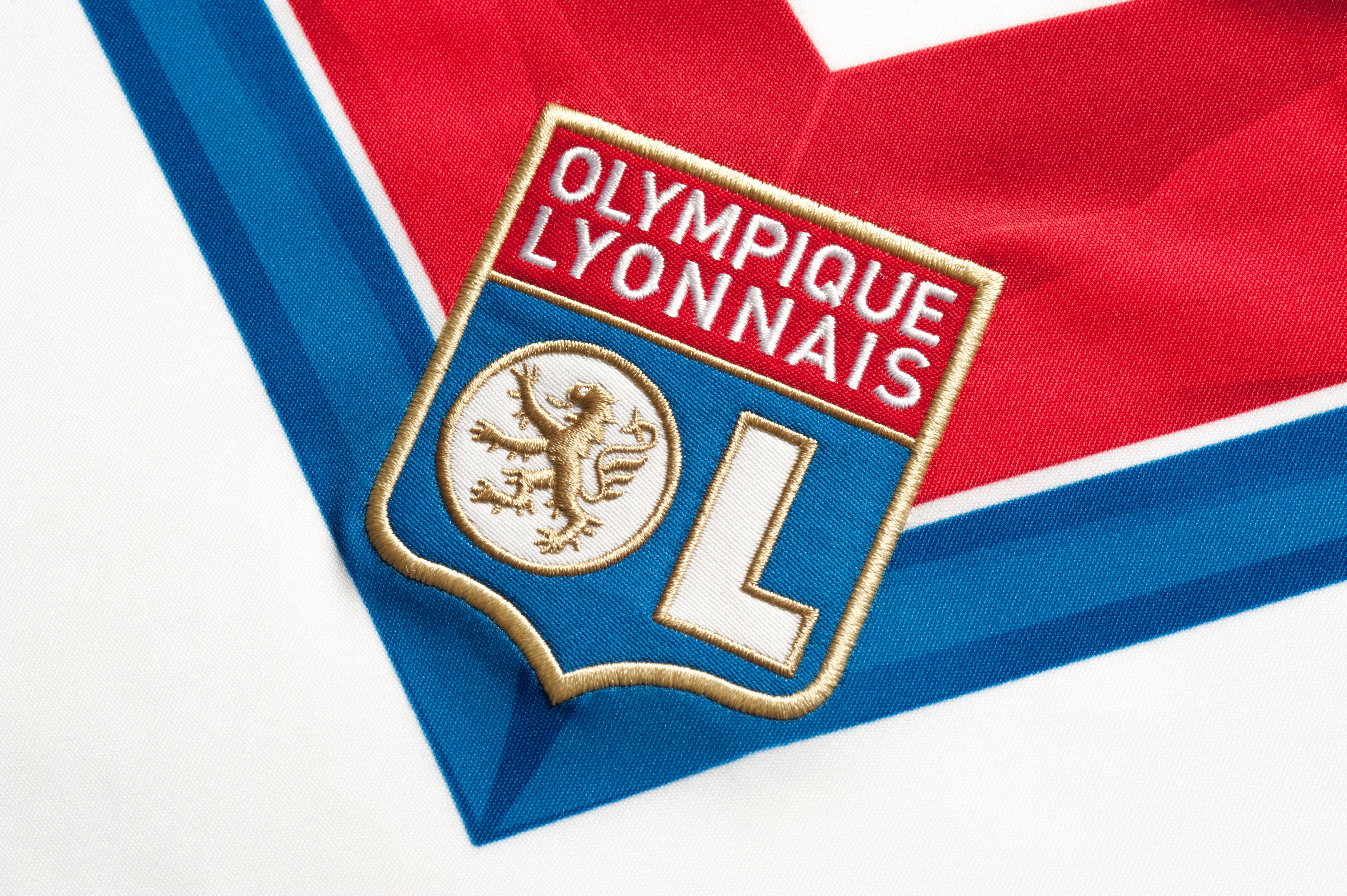 A close-up of the Lyon badge on a shirt