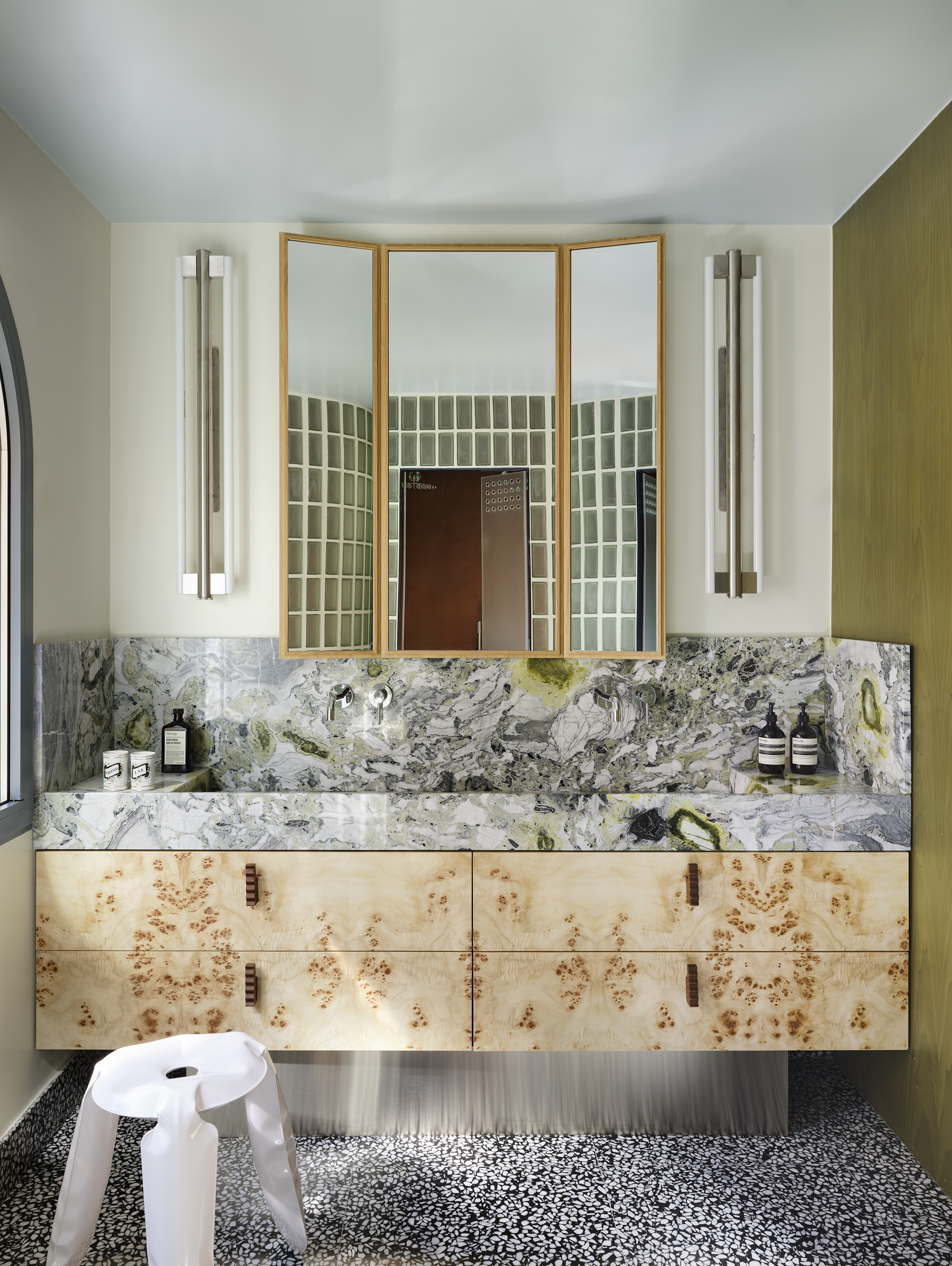 bathroom with marble vanity and terrazzo floor