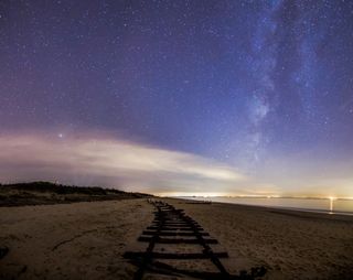 Train Tracks Uncovered Under Night Sky