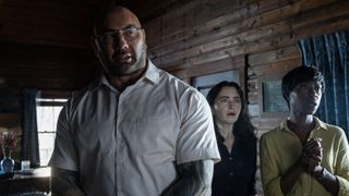 Dave Bautista, Abby Quinn and Nikki Amuka-Bird in KNOCK AT THE CABIN