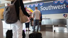 People check into the Southwest luggage desk at Chicago's Midway International Airport on May 27, 2025.