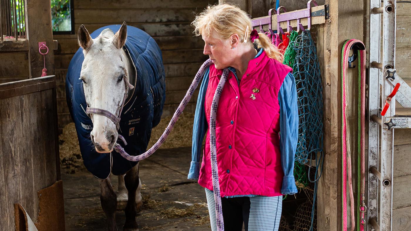 Pippa Verry leads her horse Stilton out of the stable