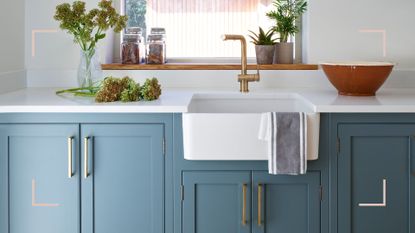 blue kitchen with white butler sink and under sink storage as an example of how to organize under the kitchen sink