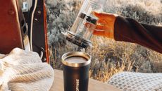 AeroPress Go Plus Complete Travel Coffee System, in camper van surrounded by fields 