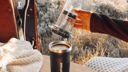 AeroPress Go Plus Complete Travel Coffee System, in camper van surrounded by fields