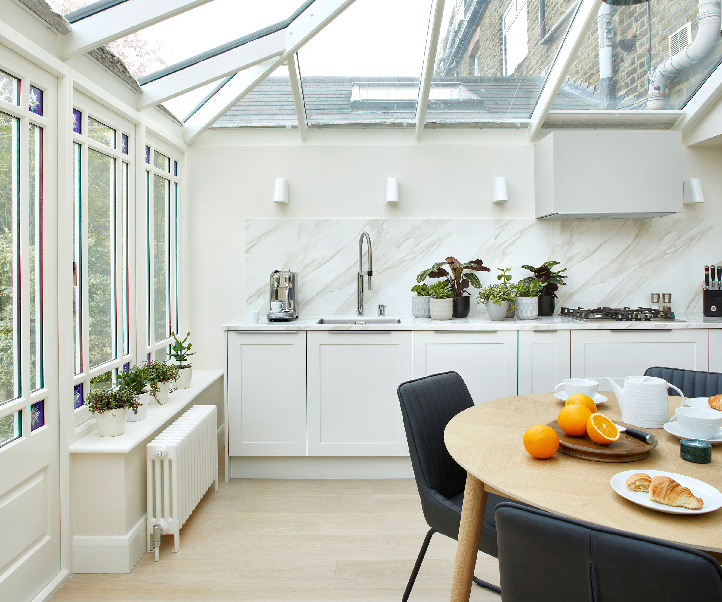 modern white kitchen orangery with timber flooring