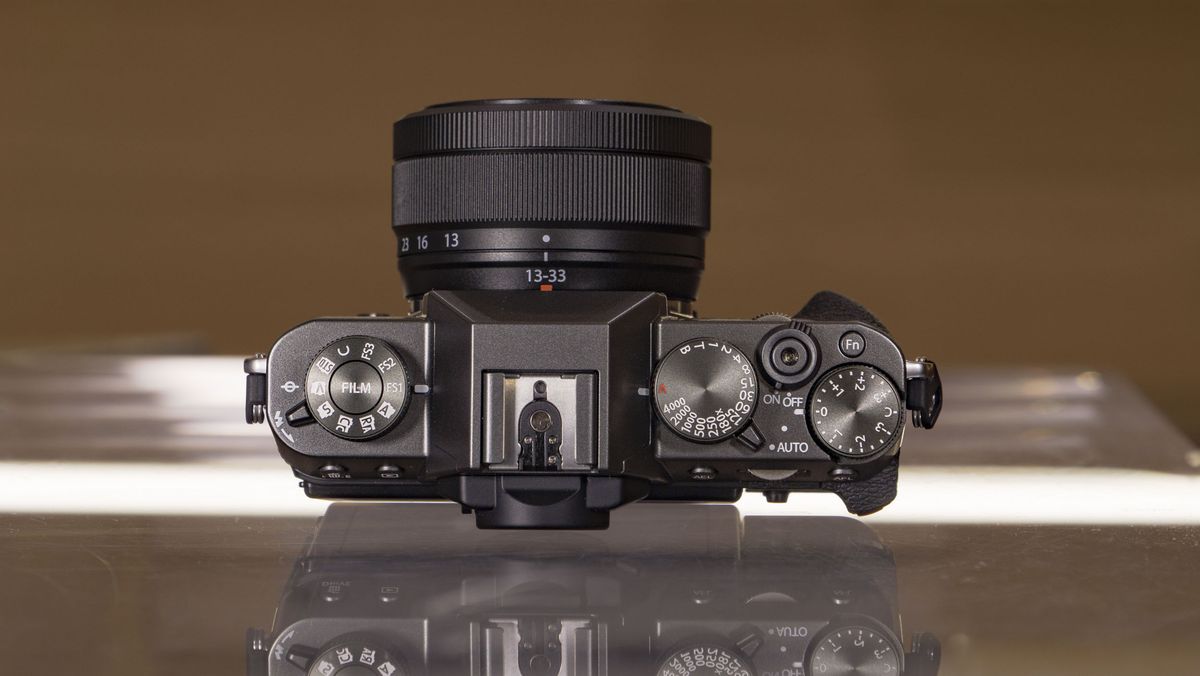 Top of the Fujifilm X-T30 III camera on a glass table