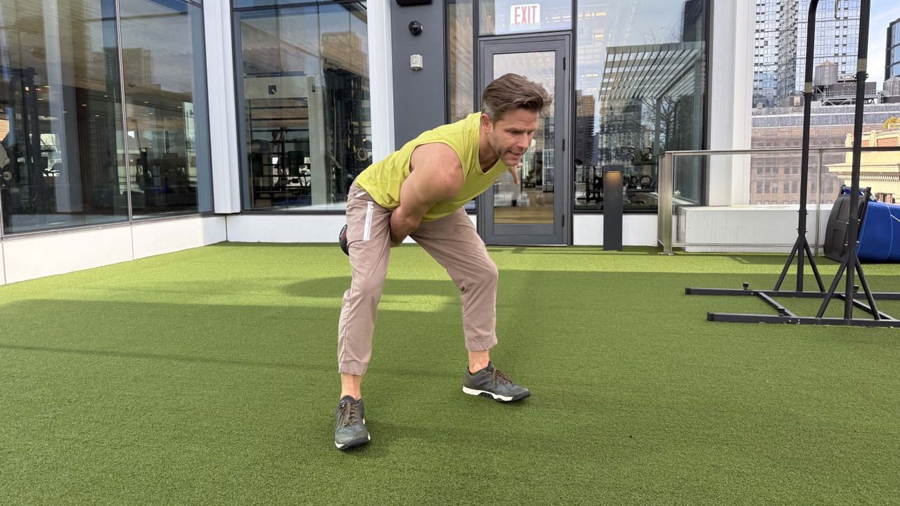 a photo of Peloton trainer Andy Speer doing a kettlebell swing