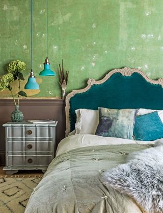 Green bedroom with blue headboard and cushions