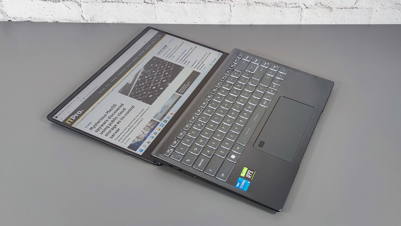 A photograph of the MSI Prestige 14 A12UC 2022 sat on a desk with the screen flat
