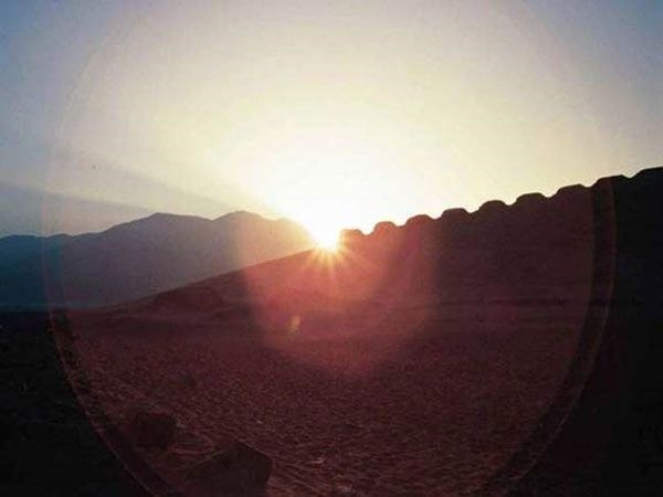 The rise of the sun is seen at a 2,300-year-old structure in Peru during the June solstice in 2003.