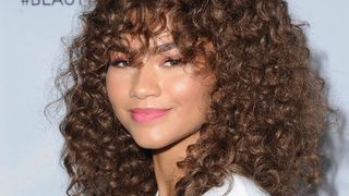 Zendaya pictured with tightly coiled curly hair