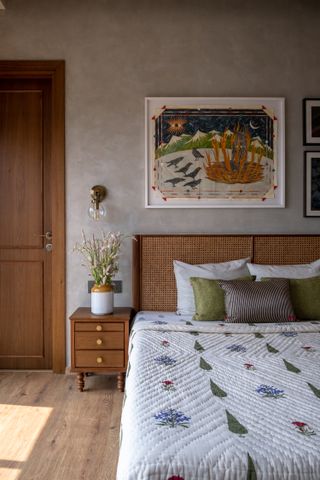 A bedroom with clay plaster walls and rattan headboard