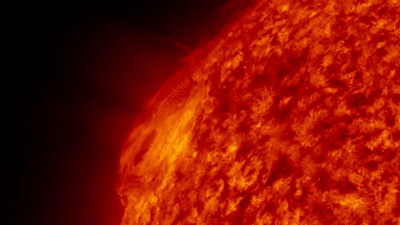 gif animation showing a large fiery eruption from the sun, it launches up into a fiery arch shape. 