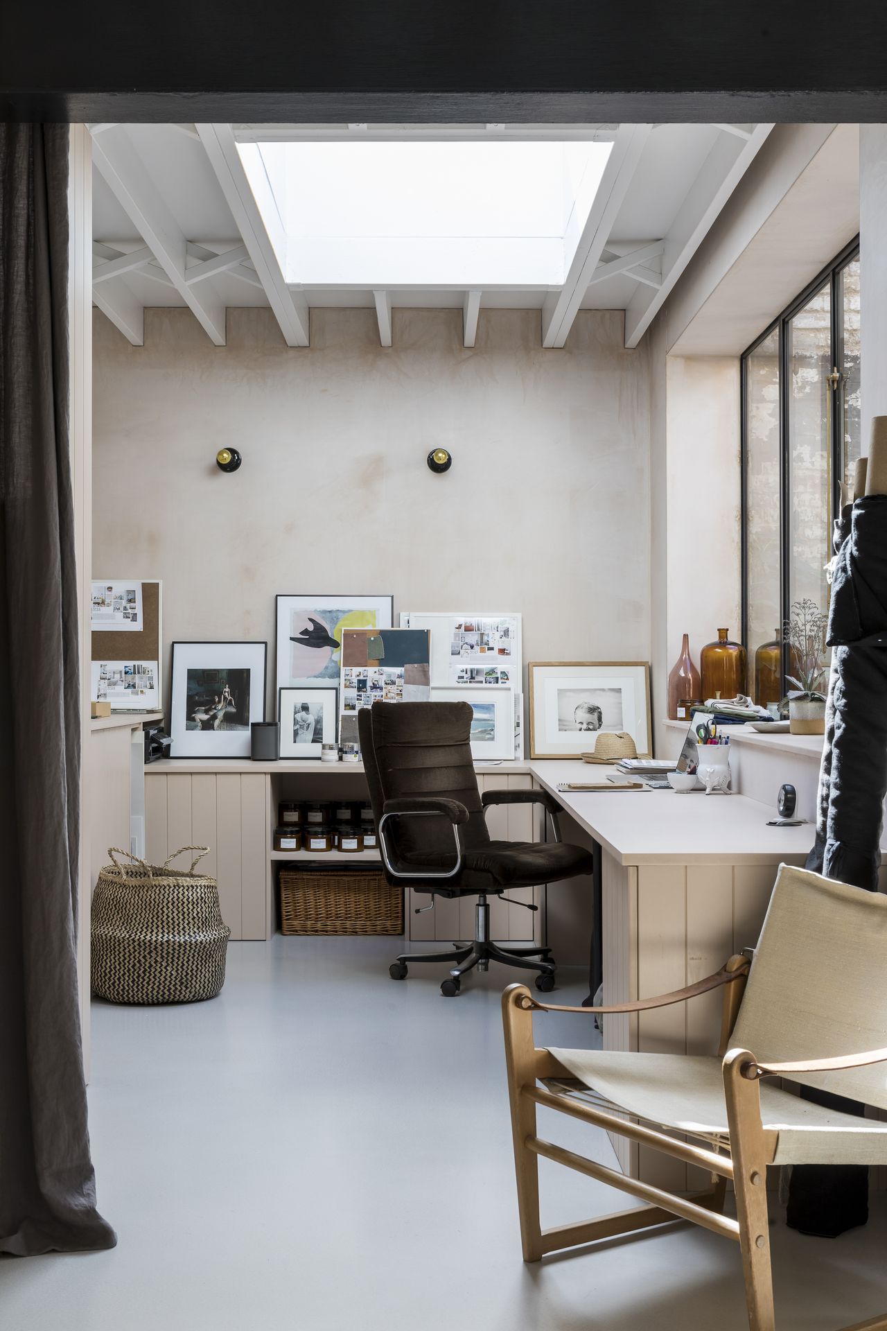 Organized corner desk in a home office with chair and pictures