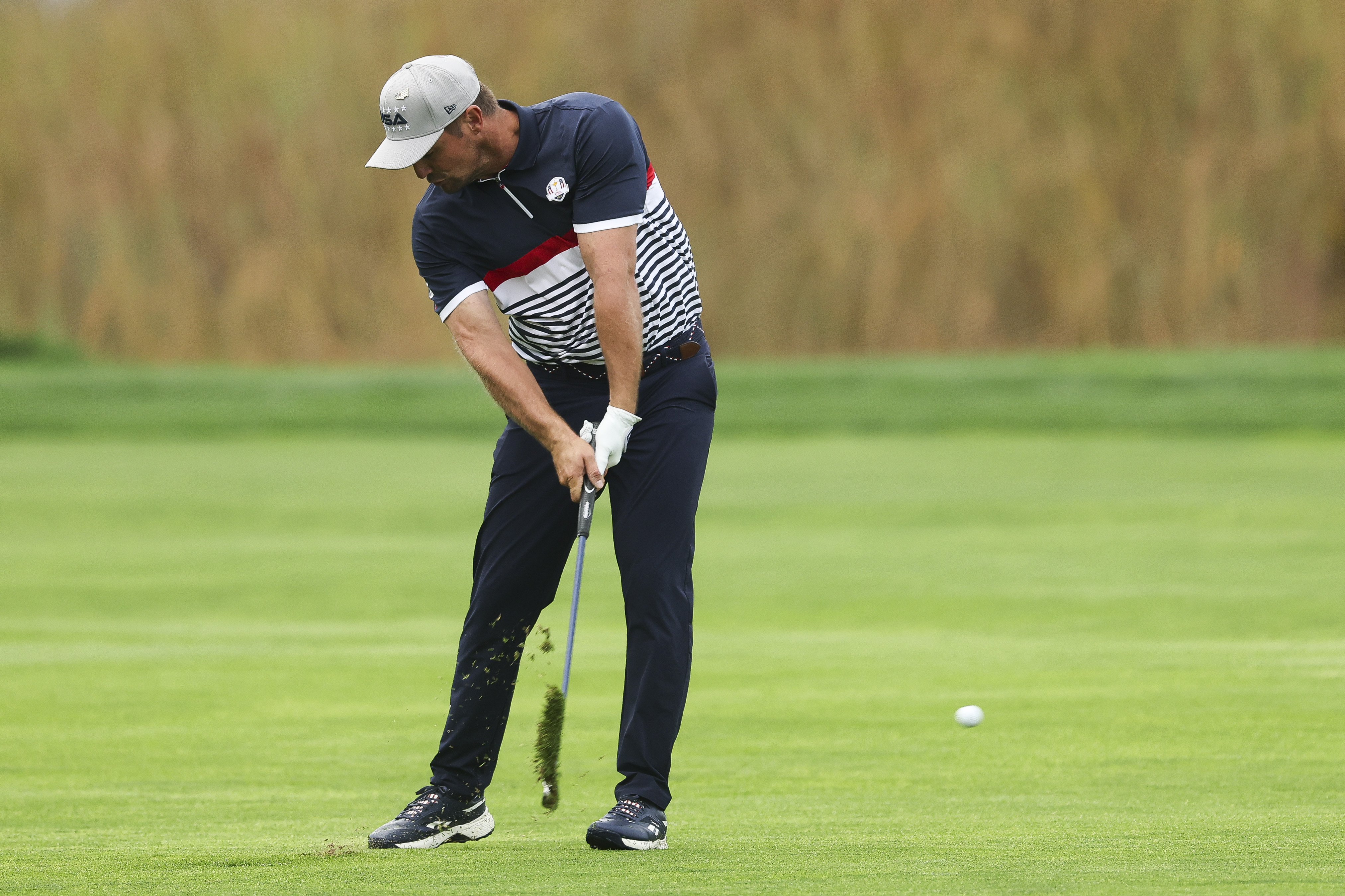 Bryson DeChambeau hits an iron shot with his graphite shafts