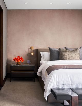 a brown bedroom with a limewash accent wall