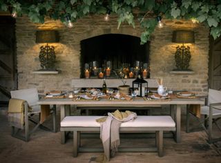 Outdoor dining area with fireplace by Neptune