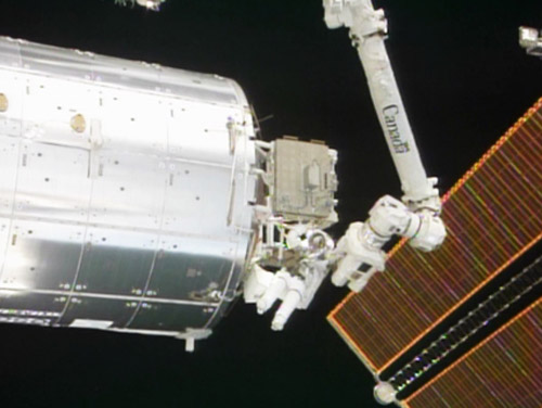 Mission Specialist Steve Bowen works outside the International Space Station during the second STS-133 spacewalk.