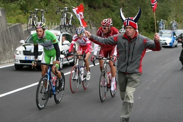 An enthusiastic spectator provides plenty of encouragement to passing riders.