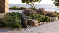 Coastal Source outdoor speakers in a woodsy environment. 