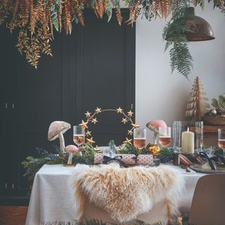 A Christmas dining table decorated with pink mushrooms