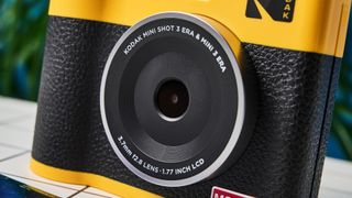 A black and yellow Kodak Mini Shot 3 Era 2-in-1 instant camera and printer