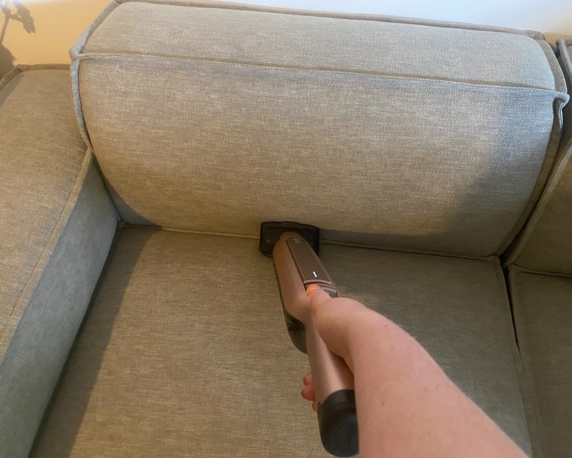 Shark Wandavac with multi surface tool cleaning a sofa