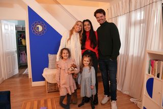 Stacey Solomon and the Watling family standing in a clean and clutter-free room