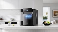 Black ice maker on white marble countertop