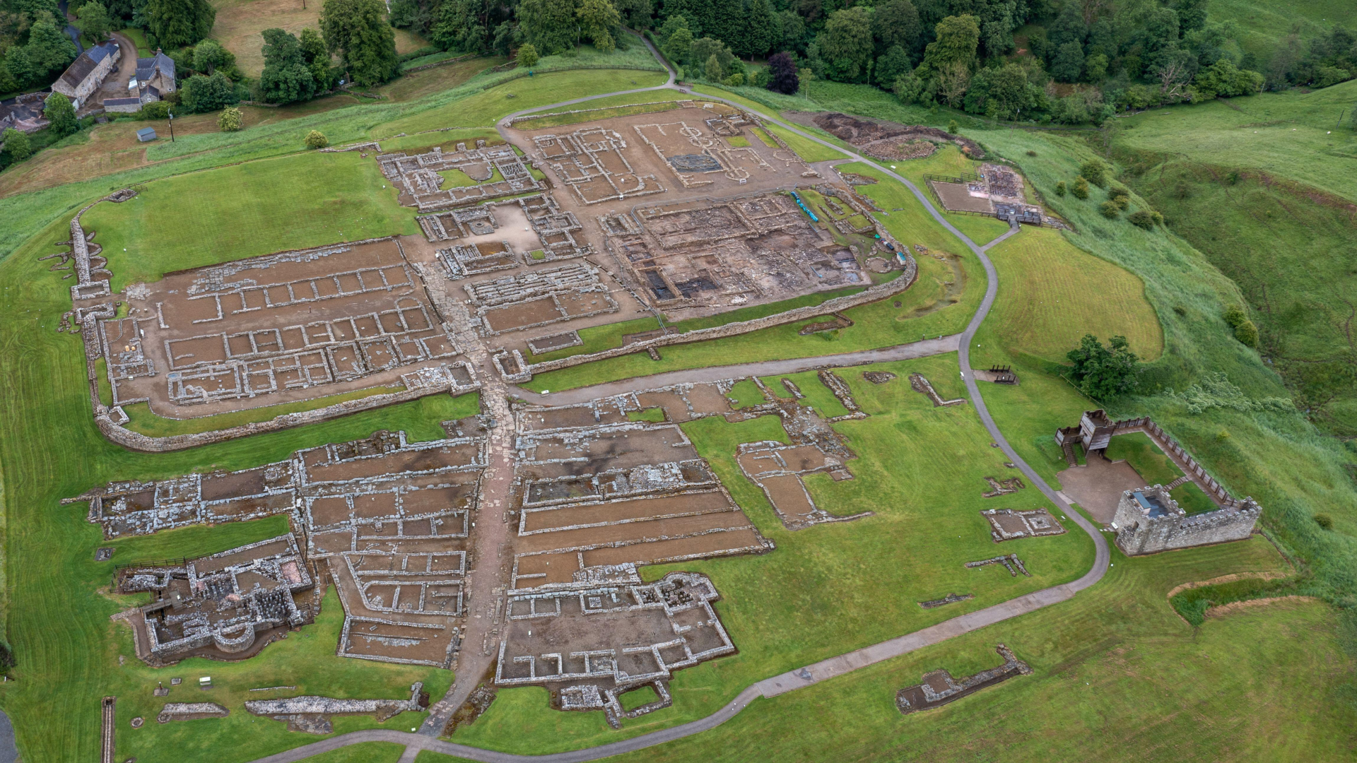 aerial view of a roman fort&#039;s ruins in a green field