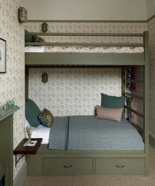 An example of loft bed ideas showing a green loft bed with two bunks in a wallpapered bedroom