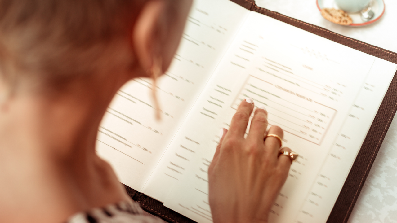 Woman reads restaurant menu