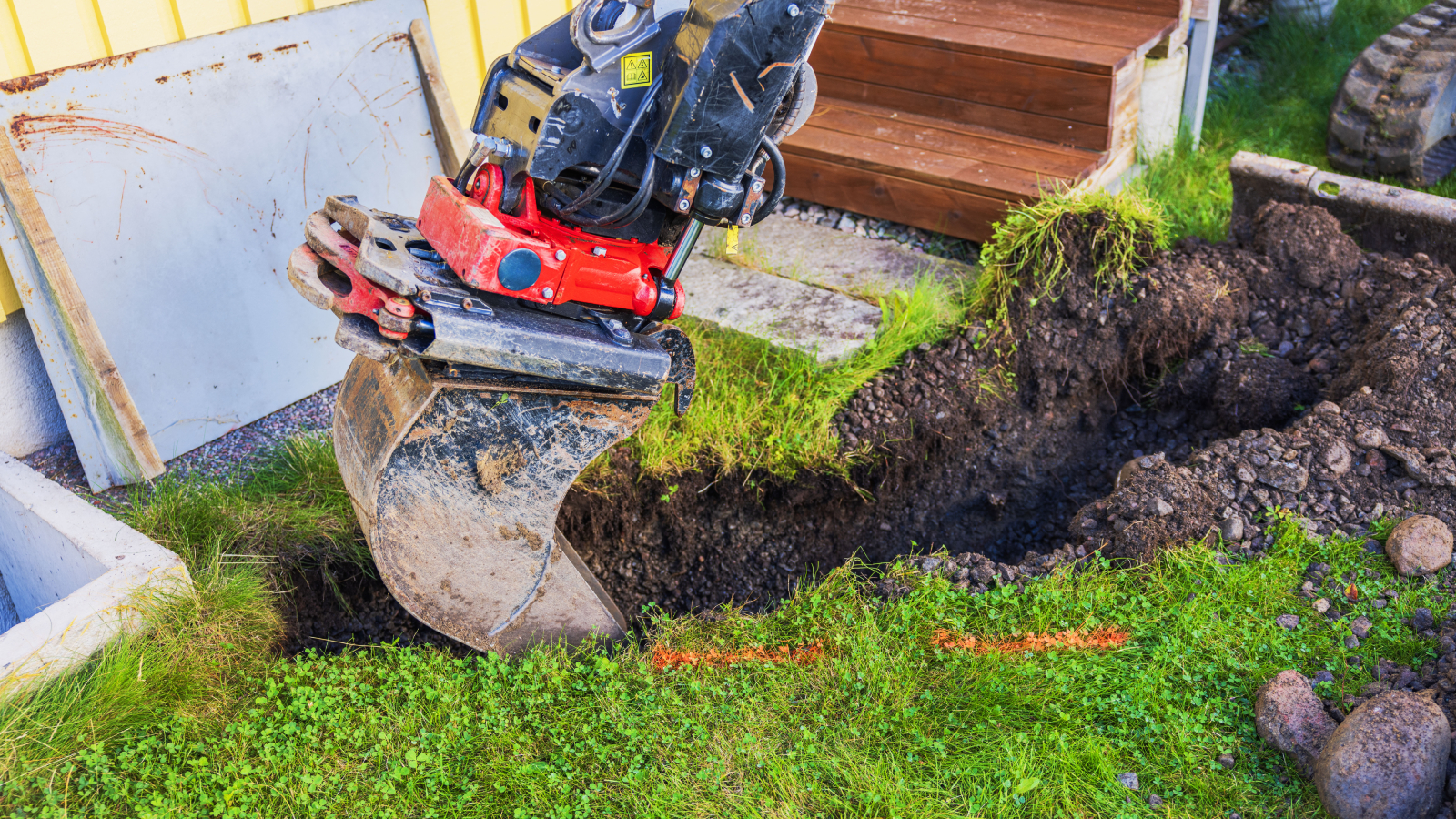 digger digging trench in garden