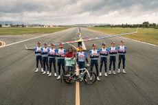 Nine Red Bull-Bora-Hansgrohe riders pulling a plane