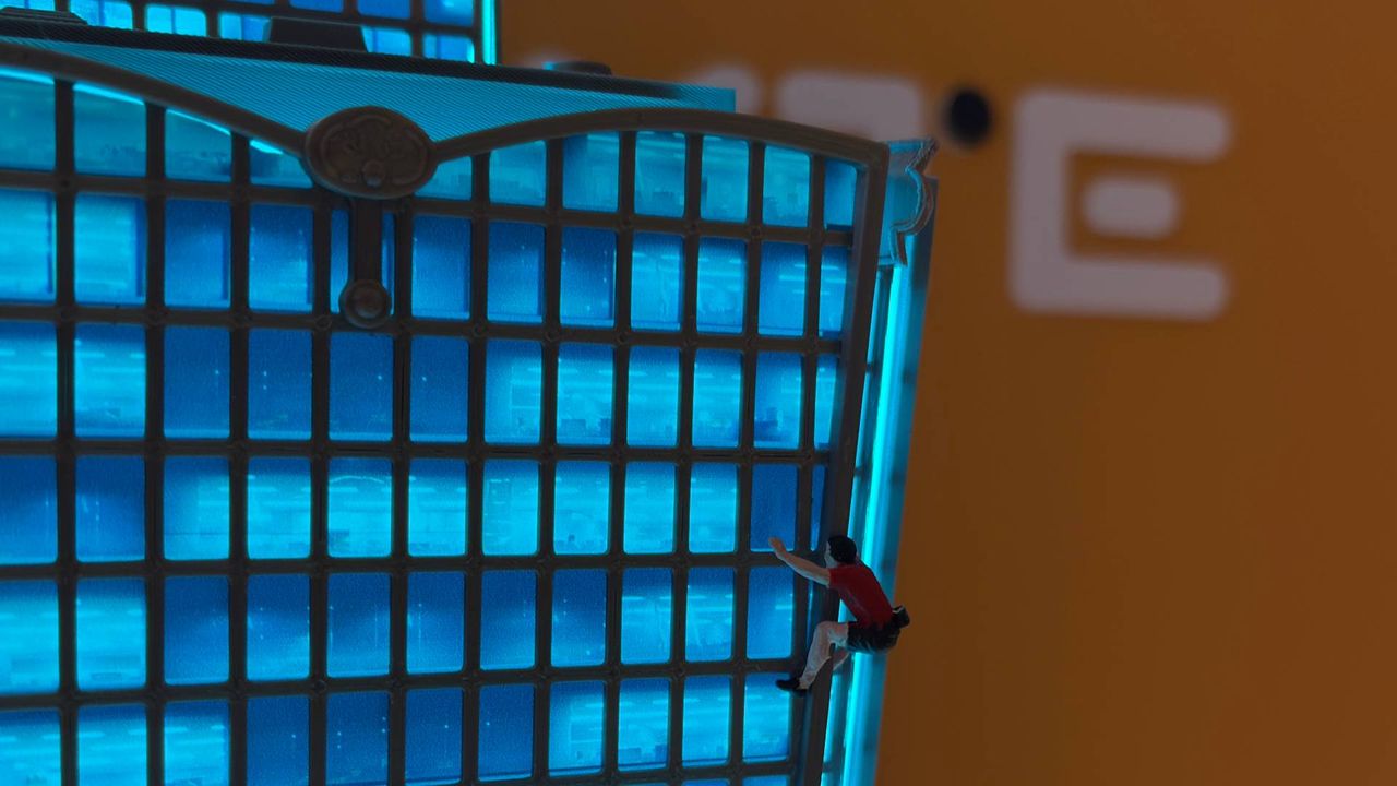 A tiny 3D printed Alex Honnold free solos up the side of a much bigger 3D printed recreation of the Taipei 101 building.