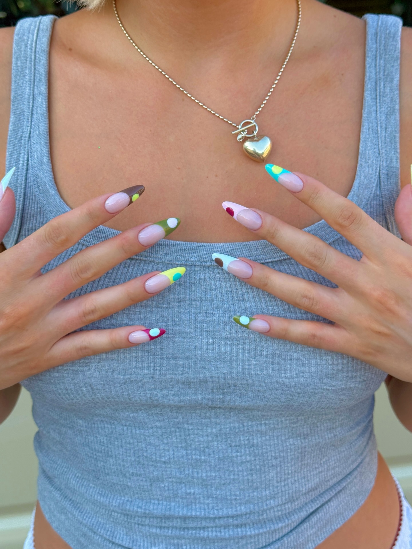 Thick French tips decorated with oversized polka dots in a bold, graphic manicure