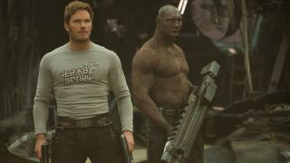 Chris Pratt and Dave Bautista stand stoically with guns in hand in Guardians of the Galaxy Vol. 2.,