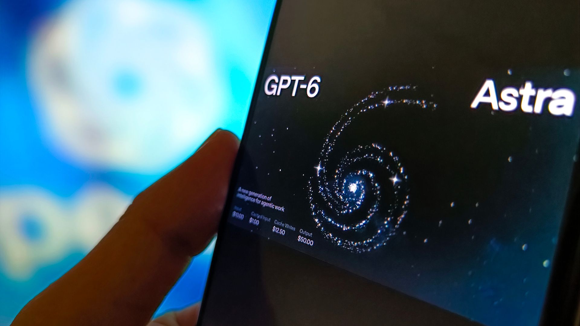 A close up of a dark phone screen showing a swirl of light with the words