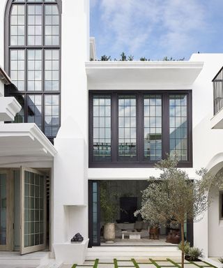 house with white walls and steel framed windows with blue sky