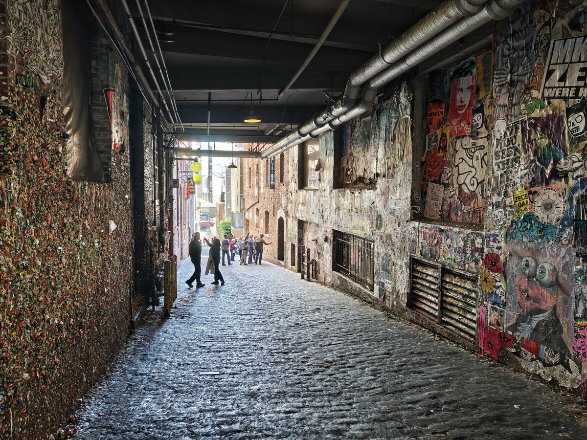 A dim alleyway with gum on a wall