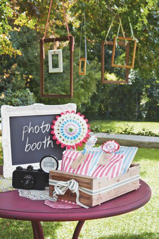 hanging frames from trees for photo booth at garden party