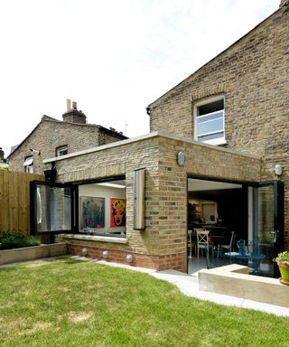 brick single storey rear extension with bi-fold doors and windows on brick house