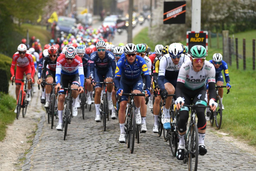 OUDENAARDE BELGIUM APRIL 04 Yves Lampaert of Belgium and Team Deceuninck QuickStep Reto Hollenstein of Switzerland and Team Israel StartUp Nation during the 105th Ronde van Vlaanderen Tour of Flanders 2021 Mens Elite a 2515km race from Antwerp to Oudenaarde Kortekeer Cobblestones sector RVV21 rondevanvlaanderen tourofflanders on April 04 2021 in Oudenaarde Belgium Photo by Tim de WaeleGetty Images