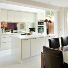 kitchen room with white tiled flooring and white kitchen cabinets