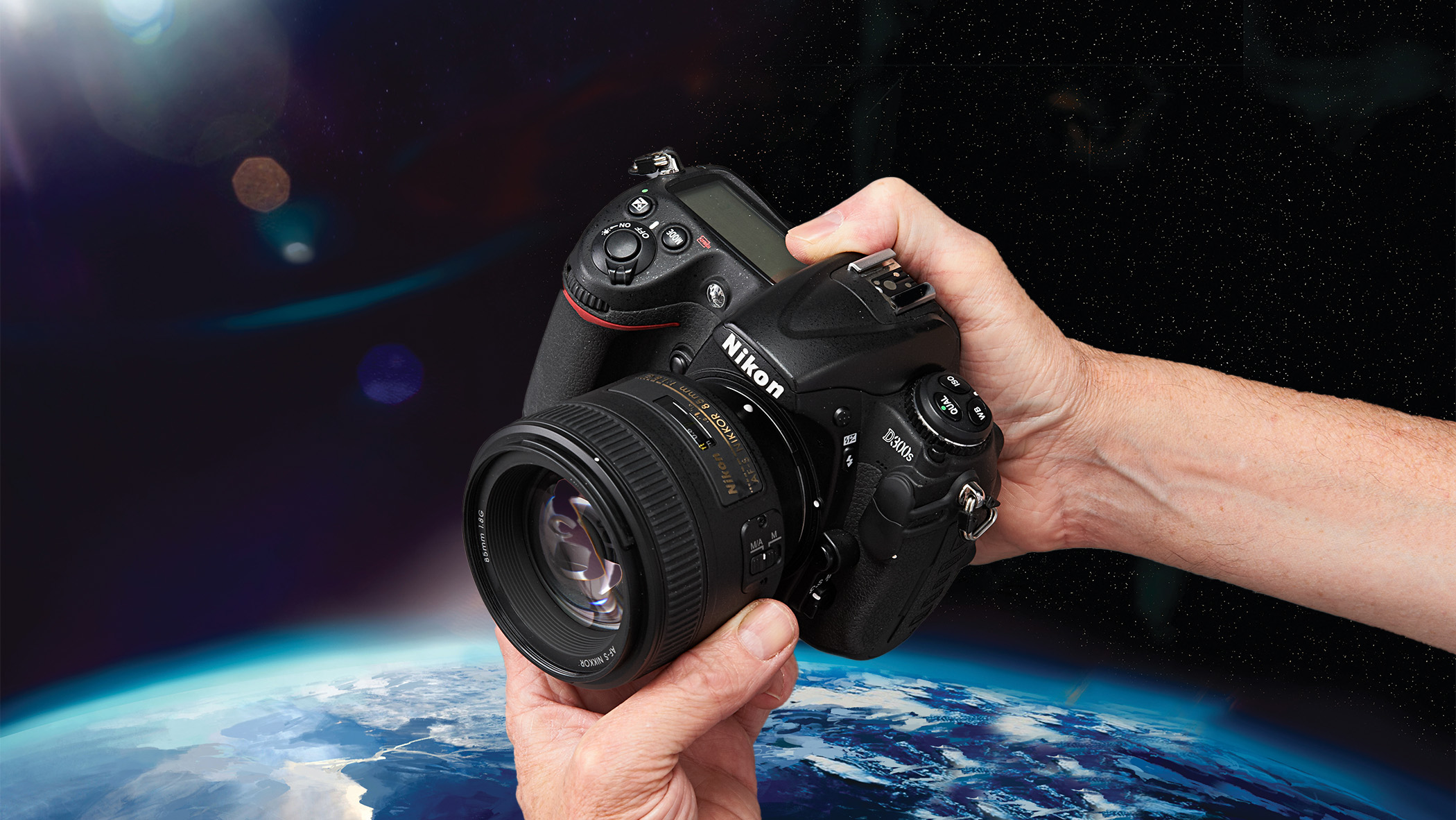 A black camera being held in space. 