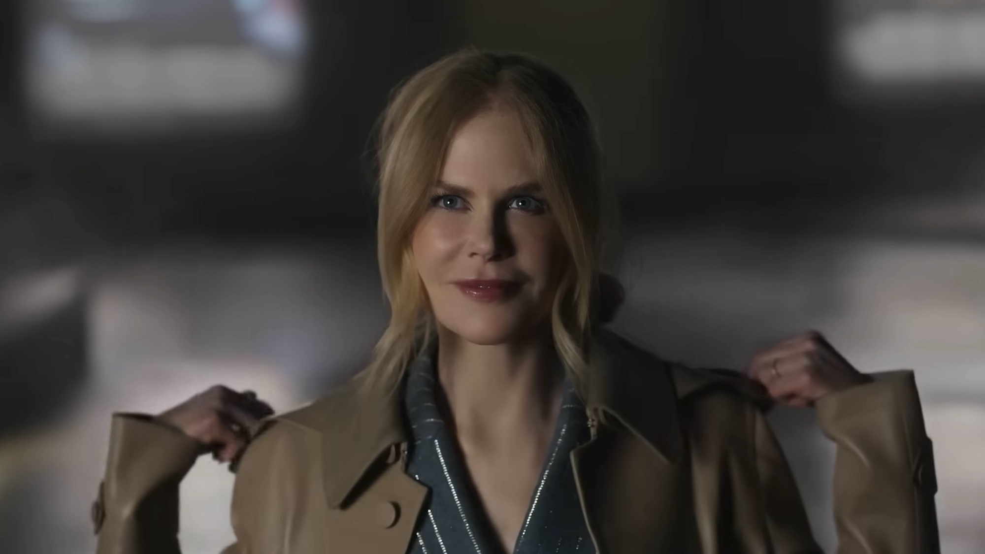 Nicole Kidman smiling in a jacket in her AMC ad.