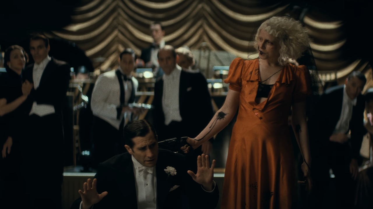 Bride holding a gun to Ronnie Reed kneeling down in The Bride!