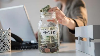 picture of woman putting money in a 401(k) savings jar