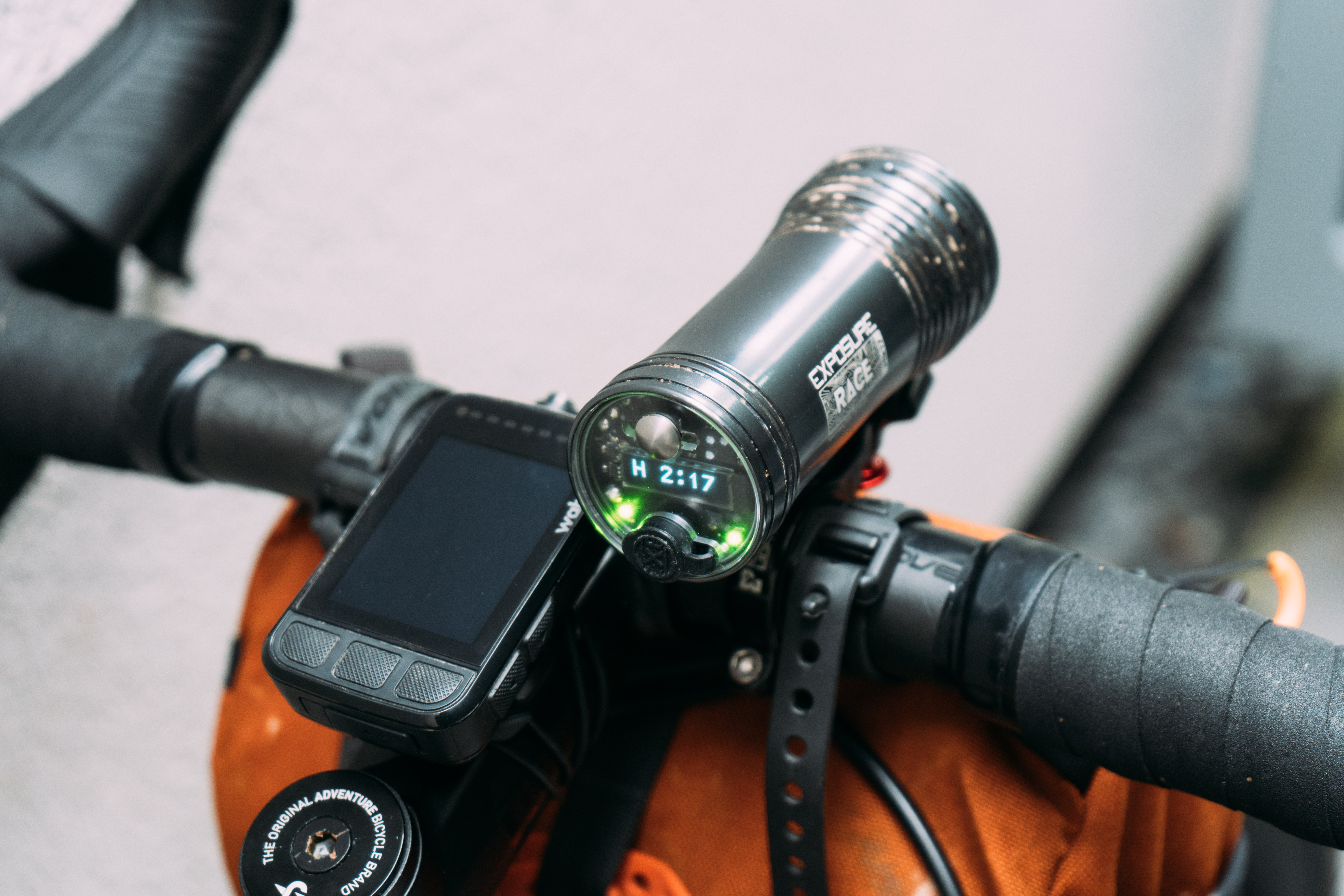 A grey bike light mounted to the bars of a gravel bike